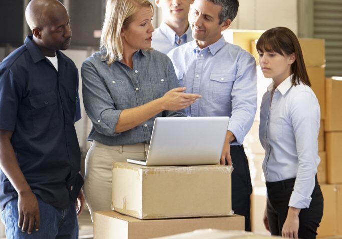 Workers In Distribution Warehouse Having A Conversation